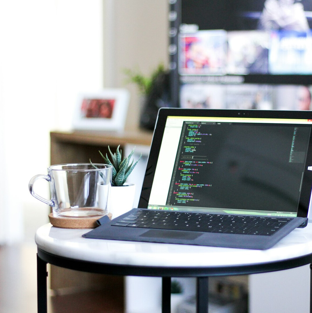 Modern coding classroom with computers and code on screens